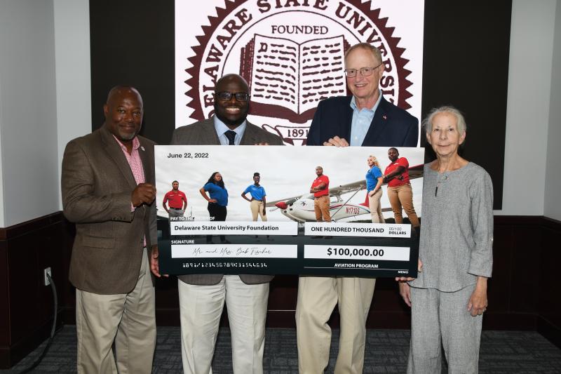 Lewes couple Bob and Karen Fischer bestowed the largest cash donation, $100,000, to the Delaware State University aviation program in its 36-year history. Gathered at the June 22 donation ceremony are (l-r) Delaware State University Aviation Program Director Lt. Col Michael Hales, Delaware State University President Tony Allen, and Bob and Karen Fischer. SUBMITTED PHOTO